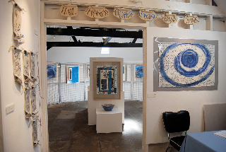 Into the round room, including Kingfisher banner (clay banner with text by Virginia Woolf) and Love flows (artist's book with text by Frances Bingham)